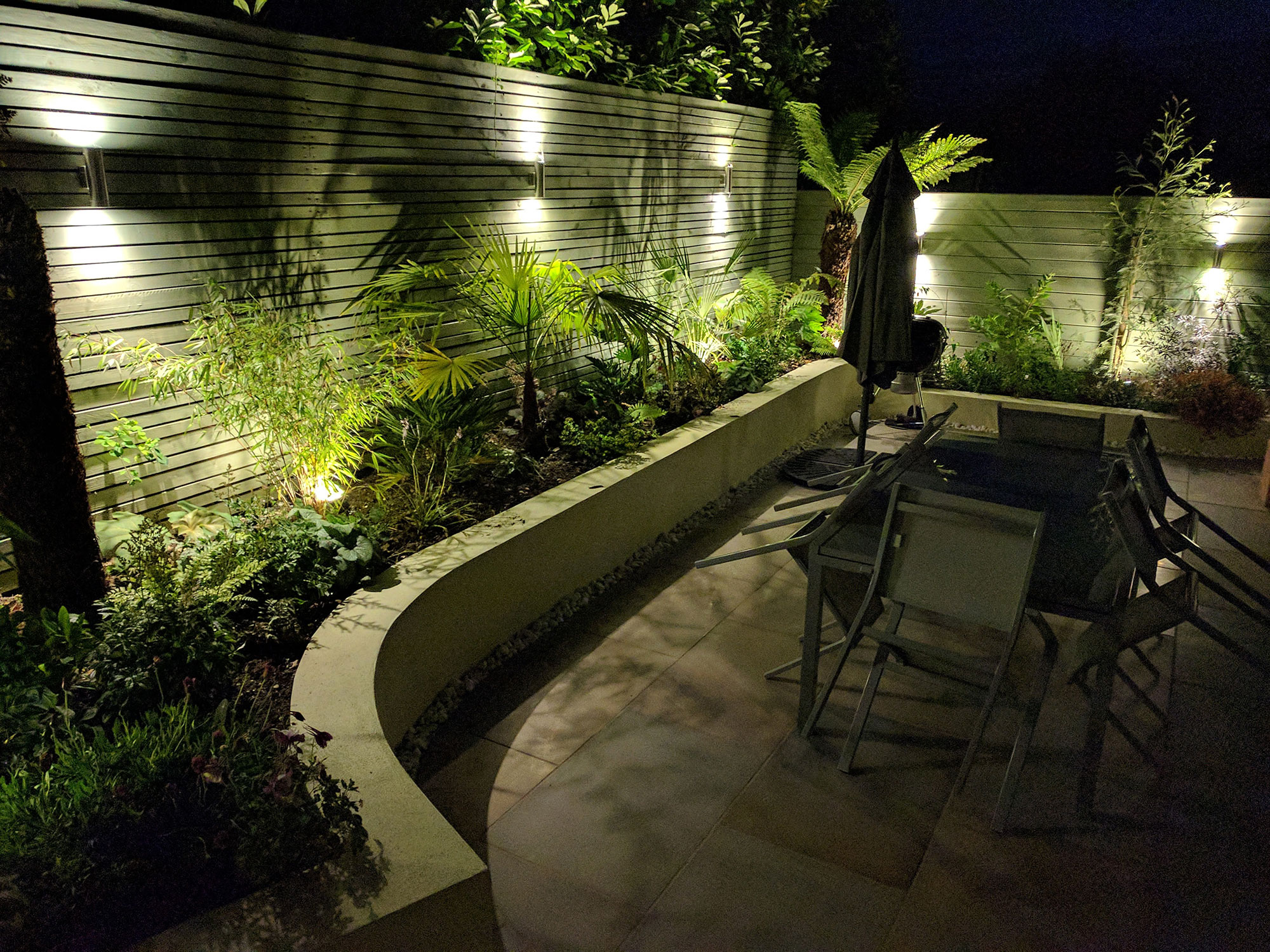 twighlight garden with planting accentuated by garden lighting