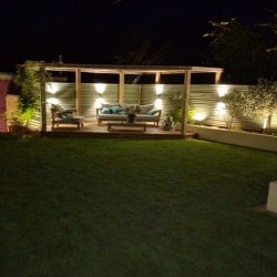 professionally built garden with timber structures and evening lighting