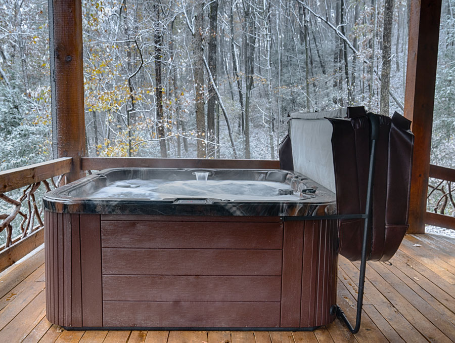 hot tub sitting on decking in a woodland setting