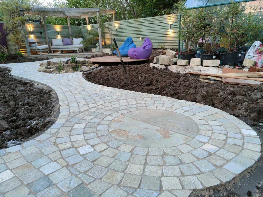 carving path with circular feature created using limestone setts