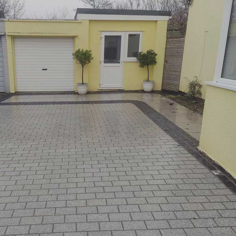 modern driveway made with grey limestone setts with black edging detail