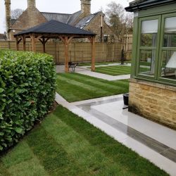 contemporary garden design using porcelain paving and natural lawn turf