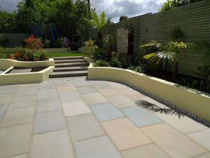 beautiful garden with large patio and steps leading to lawns