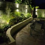 twighlight garden with planting accentuated by garden lighting