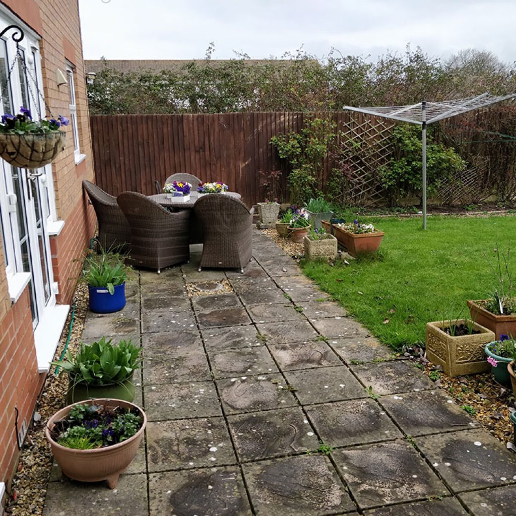 back garden before landscaping with tired patio and uninspired planting