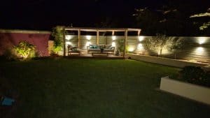 professionally built garden with timber structures and evening lighting