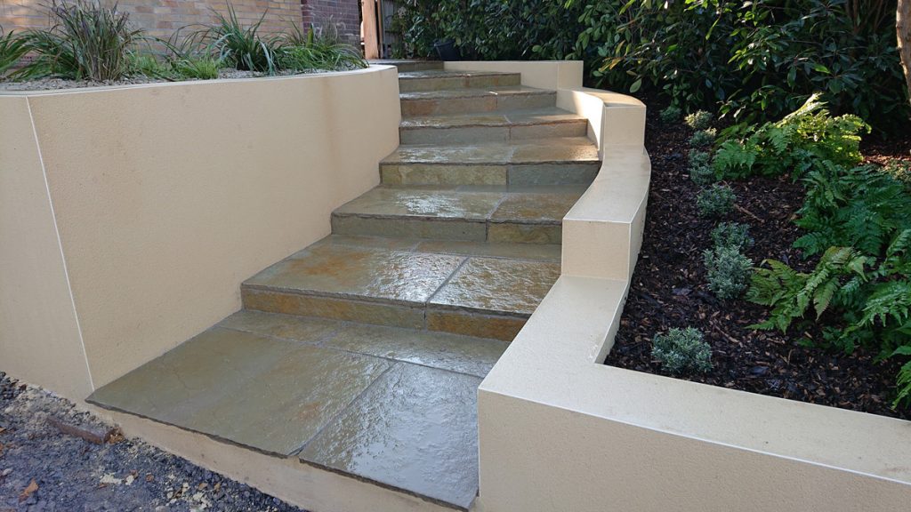 curved steps with rendered wall and limestone treads