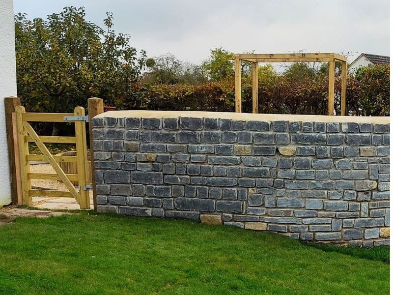 garden wall constructed using Blue Lias stone