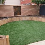 artificial lawn surrounded by raised beds